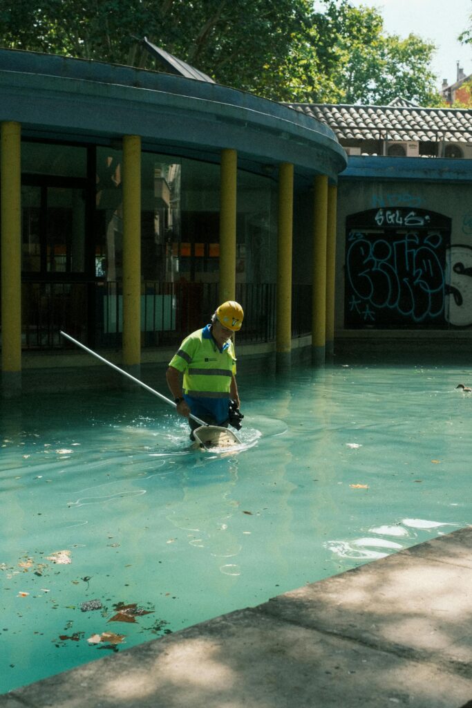 pool contractor taking out leaves